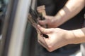 Close up of man hands removing old car window film tint Royalty Free Stock Photo