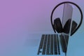 Tinted image of headphones on a black laptop keyboard with headset Royalty Free Stock Photo