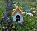 Tiny adorable fairy house under the tree in the garden