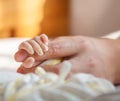 Tiny baby hand holding father finger with love Royalty Free Stock Photo