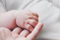 Tiny baby hand holding mother`s finger. New life, togetherness and love concept. Royalty Free Stock Photo