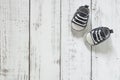 Tiny baby sneakers on wooden floor, toddler first steps, kids room background