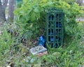 Tiny beautiful wardrobe or closet from dollhouse with magic objects of fairy, flowers and crystals outside in the garden