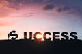 Tiny businesspeople putting backlit success letters together on sunset sky backdrop with clouds and mock up place. Teamwork,