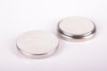 Tiny button cell batteries both sides isolated
