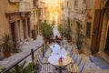 Tiny cafes with tables on stairs of narrow street,Valletta, Malta