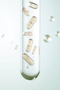 Tiny capsules suspended within a clear tube with small bubbles, representing molecular science and medical innovation. Royalty Free Stock Photo