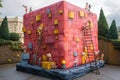 Whimsical Giant Box Surrounded by Tiny Characters Constructing It in a Vibrant Outdoor Setting Generative AI