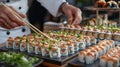 Tiny characters in red berets create sushi rolls using bamboo sticks on a wooden table, capturing intricate details in a