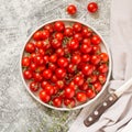 Tiny cherry tomatoes ciliegini, pachino, cocktail. group of cherry tomatoes on a gray concrete background. ripe and juicy cherry Royalty Free Stock Photo