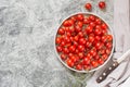 Tiny cherry tomatoes ciliegini, pachino, cocktail. group of cherry tomatoes on a gray concrete background. ripe and juicy cherry Royalty Free Stock Photo