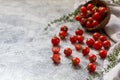 Tiny cherry tomatoes ciliegini, pachino, cocktail. group of cherry tomatoes on a gray concrete background. ripe and juicy cherry Royalty Free Stock Photo