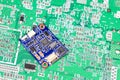 tiny circuit board, IOT device, nano computer circuit board isolate on green computer circuit board Royalty Free Stock Photo