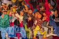 Tiny colorful string puppets hanging on a wall for sale at Olvera Street in Los Angeles California