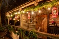 Tiny and Cozy house Cabin Exterior with Christmas lights. Ideal picture that brings up holiday spirit Royalty Free Stock Photo