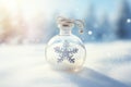 Tiny cute Snowflake contained within a sphere glass bottle on snow background Royalty Free Stock Photo