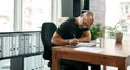 A tiny detail can change the whole design. a mature businessman filling out paperwork at his desk in a modern office. Royalty Free Stock Photo