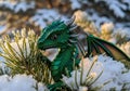 Tiny Dragon Peeking from Behind a Snowy Bush Royalty Free Stock Photo