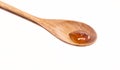 Tiny drops of honey in a wooden spoon Royalty Free Stock Photo