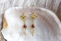 Tiny elegant female earrings with mineral stone beads