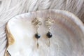 Tiny elegant female earrings with mineral stone beads