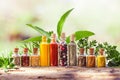 Tiny glass containers with spices and peppers on old wooden board