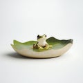 Tiny Green Frog Sits on a Lily Pad Shaped Dish Royalty Free Stock Photo