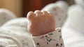 Tiny hand of newborn baby clenched into fist in bedroom Royalty Free Stock Photo