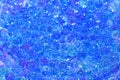 Tiny hard plastic beads balls in blue color background