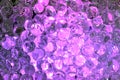 Tiny hard plastic beads balls in purple color background