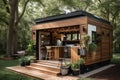 a tiny home with a full outdoor kitchen and dining area, surrounded by greenery Royalty Free Stock Photo