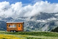 A tiny home on wheels in a picturesque landscape.