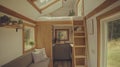 This tiny house features a cozy living area, a compact kitchen, and a lofted bed Royalty Free Stock Photo