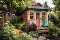 tiny house in lush, colorful garden setting