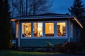tiny house at night with warm light from windows Royalty Free Stock Photo