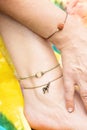 Tiny jewelry on female hand and leg