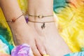 Tiny jewelry on female hand and leg