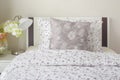 Tiny lavender pattern style bedding in bedroom with white orchid Royalty Free Stock Photo