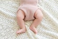 Tiny little newborn baby's feet in woolen shorts