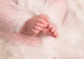 Tiny little toes of infant sleeping wrapped up in blanket