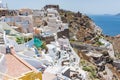 Tiny little white houses, hotels and long stairway to the harbour in the Oia village at Santorini, Greece.