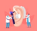 Tiny Male Female Doctors Fitting Deaf Aid on Huge Patient Ear. Hearing Loss Medical Health Problem, Otolaryngology Royalty Free Stock Photo