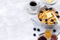Tiny mini pancake cereal. Home made breakfast with blueberries, jam and coffee on gray background