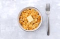 Tiny mini pancake cereal. Home made breakfast with butter on gray background