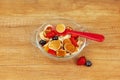 Tiny mini pancakes lie in a transparent glass bowl, decorated with blueberries and strawberries. Brunch, Breakfast for children Royalty Free Stock Photo