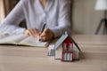 Tiny model of country house on table of realtor