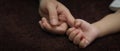 Tiny newborn baby hand  holding finger of parent Royalty Free Stock Photo