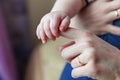 Tiny newborn infant male or female baby hand holding mother finger Royalty Free Stock Photo