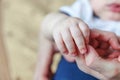 Tiny newborn infant male or female baby hand holding mother finger Royalty Free Stock Photo