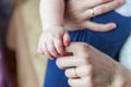 Tiny newborn infant male or female baby hand holding mother finger. Mother holding her newborn child. Family maternity, tenderness Royalty Free Stock Photo